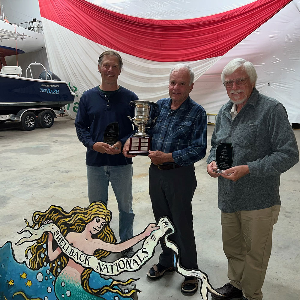 Nick Robinson, George Knapp and Peter Hrabchak standing and holding awards from the 2024 Shellback Nationals